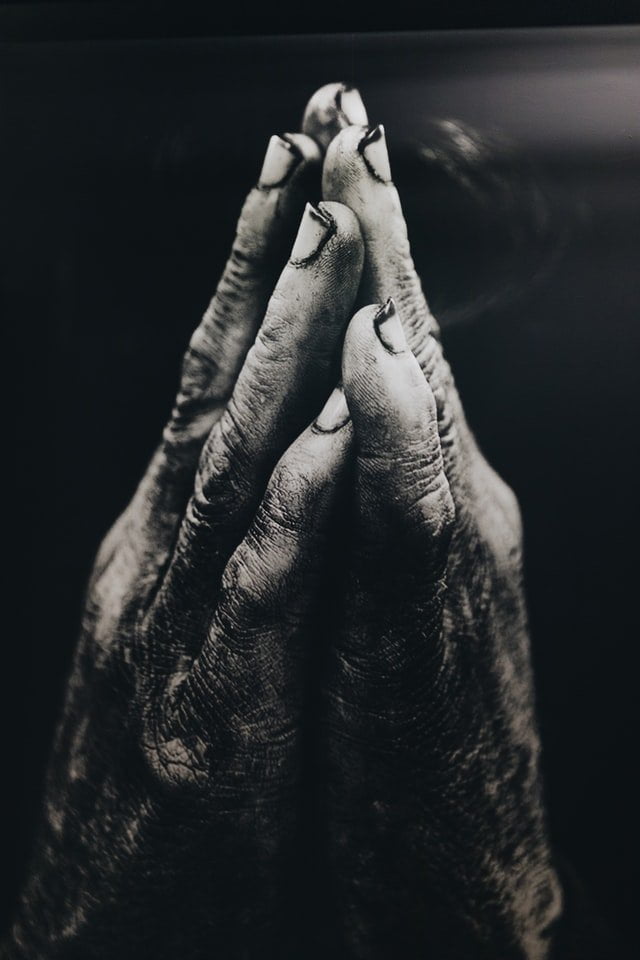 weathered hands praying