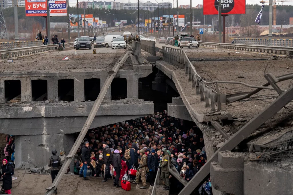 Ukrainian citizens seeking shelter under a bridge.